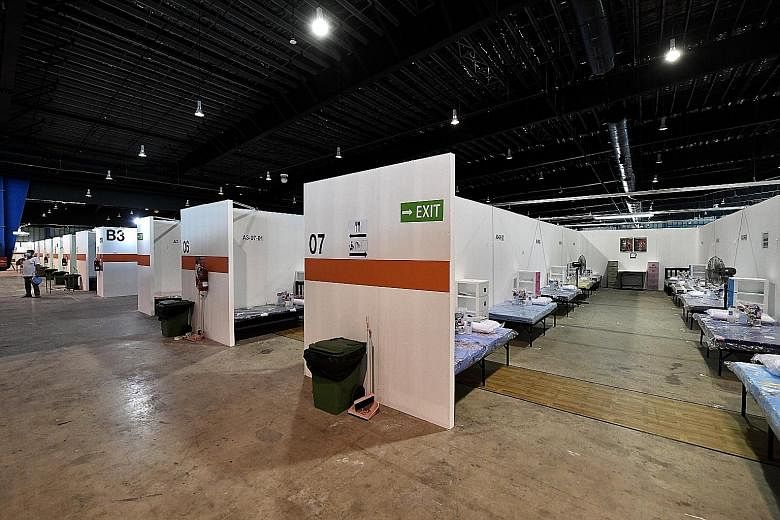 Fit-out works for community isolation facilities such as Changi Exhibition Centre (left) are contracted through the emergency procurement procedure. ST FILE PHOTO