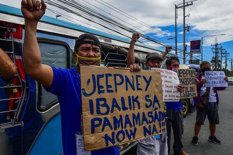 Jeepney drivers chanting slogans during a protest in Quezon city in the Metro Manila area on Monday, calling on the government to allow them to return to work. PHOTO: AGENCE FRANCE-PRESSE