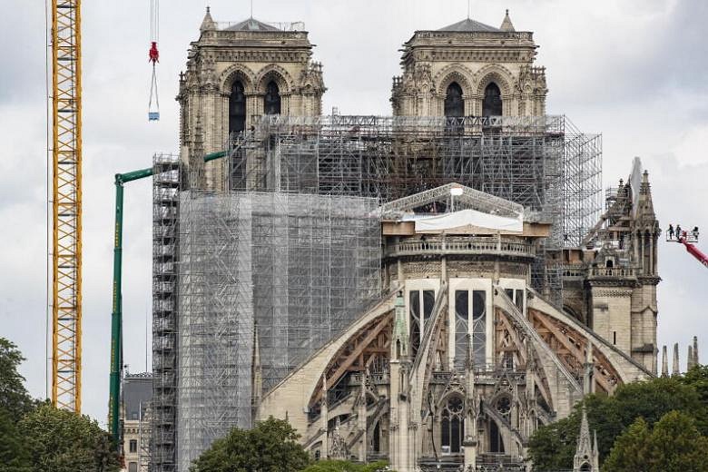 Workers start to remove charred scaffolding around Notre-Dame Cathedral ...