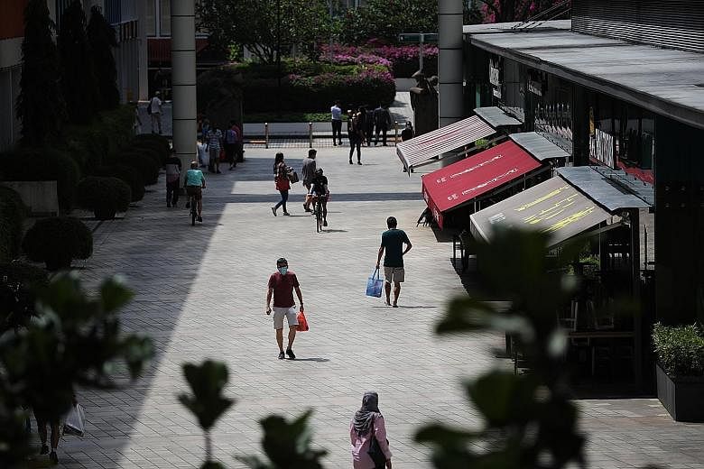 People in Toa Payoh Central yesterday. The Ministry of Health's director of medical services Kenneth Mak said that as more people leave their homes for work, it is "still important to remember that we should limit travel outside our home and continue