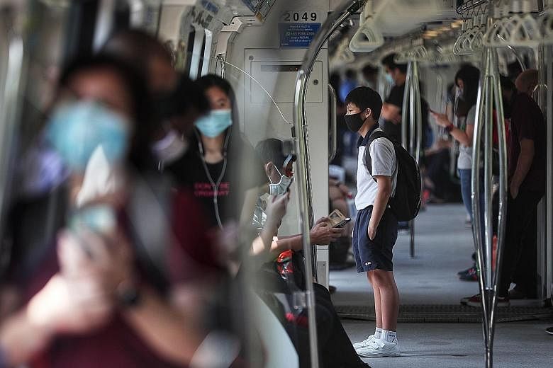 Commuters on an MRT train yesterday. As new evidence emerged, the authorities here changed their advice on the wearing of masks, and people's willingness to adapt has been invaluable in the fight against Covid-19, said Deputy Prime Minister Heng Swee