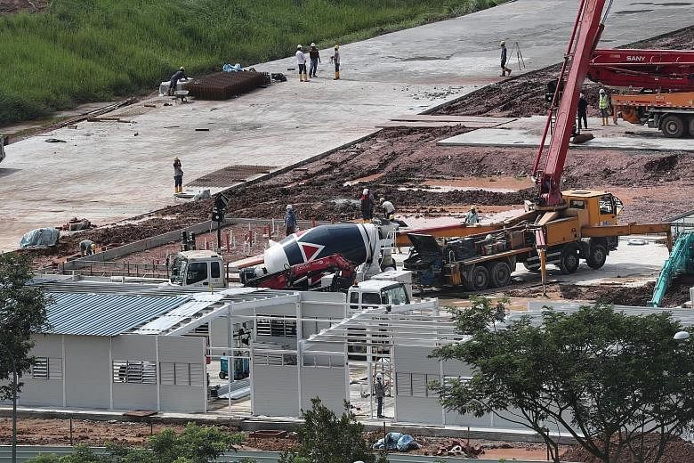 Work in progress at a construction site in Choa Chu Kang Grove last week. The Government will build new workers' dormitories designed to be more resilient against infection risks. ST PHOTO: KELVIN CHNG