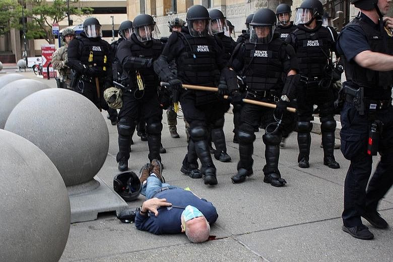 Mr Martin Gugino lying injured on the ground after he was shoved by two police officers during a protest in Buffalo, New York, on June 4. PHOTO: REUTERS