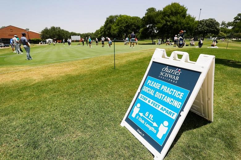A sign at the Colonial Country Club reminding people to maintain social distancing during a practice round before the Charles Schwab Challenge, which tees off today after the PGA Tour's Covid-19 break.