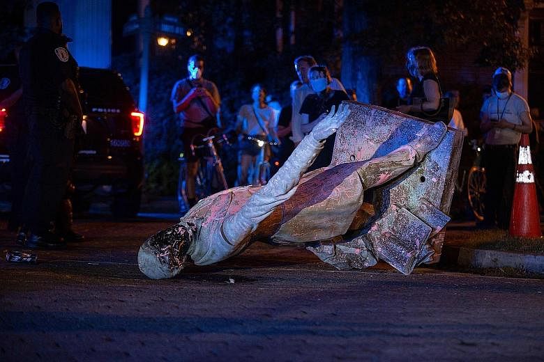A statue of Confederate States President Jefferson Davis lying on the street after protesters pulled it down in Richmond, Virginia, on Wednesday. Nationwide protests over the police killing of Mr George Floyd have led to calls in the United States to