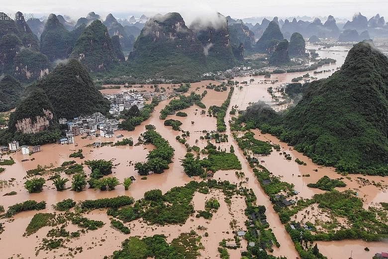 A flooded village in Yangshuo county in Guangxi Zhuang Autonomous Region, where six people were reported dead and one missing, on Sunday. People in Yangshuo, a popular tourist destination, had to evacuate on bamboo rafts.