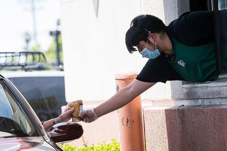 A Starbucks drive-through station in California. The firm plans to accelerate the roll-out of its pickup store concept, with smaller-format locations without customer seating. It says the pandemic has forced it to rethink its central concept of being