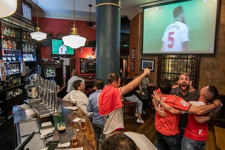 Sevilla supporters in a bar in Seville celebrating the opener by Lucas Ocampos against Betis on Thursday.