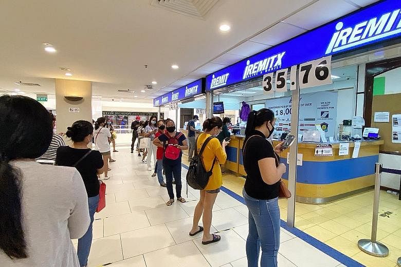 The queue outside a remittance service at Lucky Plaza on June 4, days after the circuit breaker ended. The Monetary Authority of Singapore said yesterday it has worked with all licensed remittance agents at City Plaza, Lucky Plaza and Peninsula Plaza
