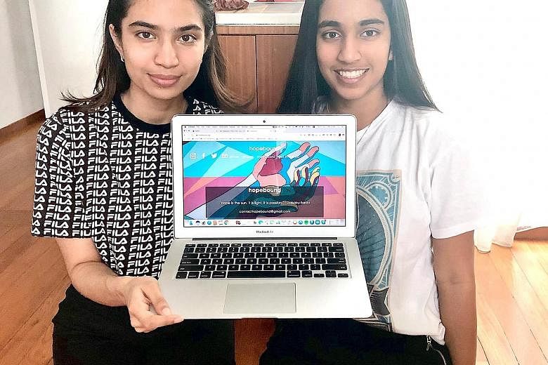 Ms Nishka Menon (left), 21, and her sister Ayesha, 17, showing their website hopebound, which collates resources for people affected by the coronavirus pandemic.
