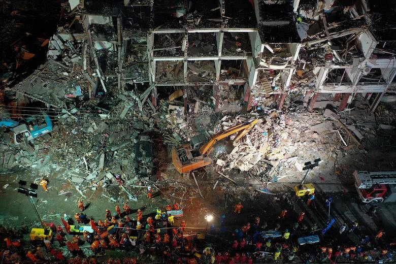 Rescuers searching for survivors in a building damaged by a tanker explosion near Wenling, in China's eastern Zhejiang province, last Saturday. PHOTO: AGENCE FRANCE-PRESSE