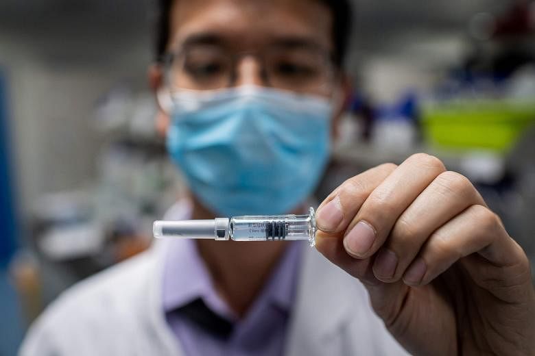 A Sinovac engineer with an experimental vaccine for the coronavirus in April. It is among five Chinese vaccines at the crucial final stage of human testing before they can be approved for public use.