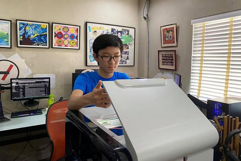Mr Marcus Chu working on his 3D printer at home printing frames for face shields in Manila in April. Working remotely is fine for the IT and services sectors, said the Philippines' acting economic planning secretary Karl Chua.