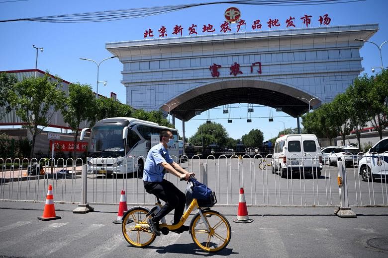 A security officer riding past the closed Xinfadi Wholesale Market in Beijing yesterday. Fengtai, the area where the market is located, has been declared a high-risk area. Those who visited the market on or before May 30 have been asked to voluntaril