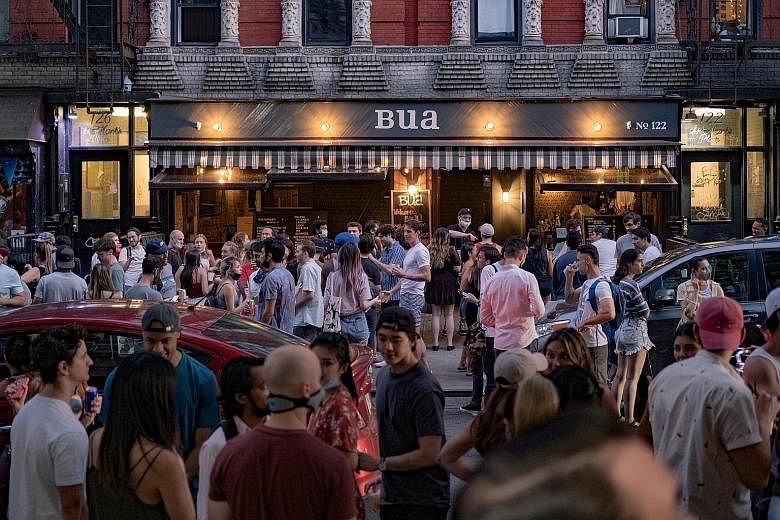 Left: A bar in the East Village neighbourhood of New York City last Friday. New York Governor Andrew Cuomo said the state has received 25,000 complaints recently of violations of social distancing and other emergency requirements. PHOTO: REUTERS Belo
