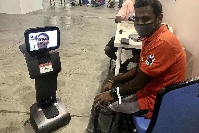 A patient at SingHealth's community care facility at the Singapore Expo having a teleconsultation via Temi, a remote-controlled robot. PHOTO: SINGHEALTH