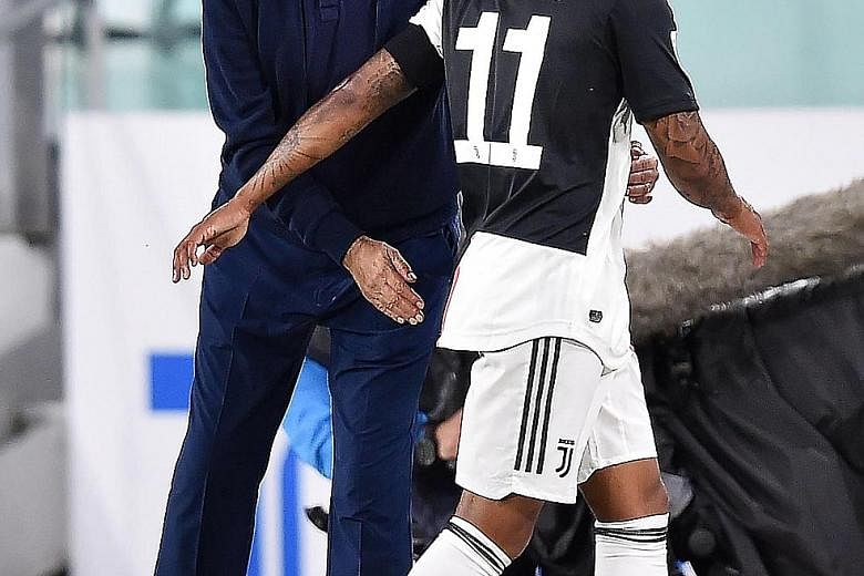 Juventus coach Maurizio Sarri with Douglas Costa after taking him off in the second leg of the Italian Cup semi-final against AC Milan last Friday.