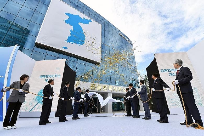 Above: South Korean and North Korean delegates taking part in an opening ceremony for the inter-Korean liaison office in Kaesong, North Korea, in September 2018. Left: A TV news report showing an explosion at the liaison office yesterday. North Korea