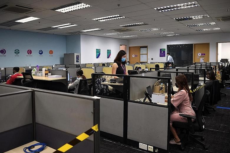 Call centre agents at Enterprise Singapore's call centre in Tai Seng. Trade and Industry Minister Chan Chun Sing said the agents do not just address queries, but also facilitate communication between businesses and government agencies. ST PHOTO: KUA 