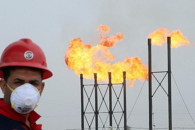 A worker at an oil field in Iraq. The country, which had one of the worst compliance rates among major oil producers, has made deep cuts to its crude supplies to Asia next month. Elsewhere, shale producers in the United States are also cutting back o