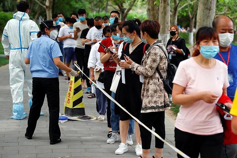 People lining up for a nucleic acid test in Fengtai district yesterday, after the outbreak in Beijing. The city has classified at least one community as high risk and subjected its residents to quarantine, and 32 others as medium risk. PHOTO: REUTERS