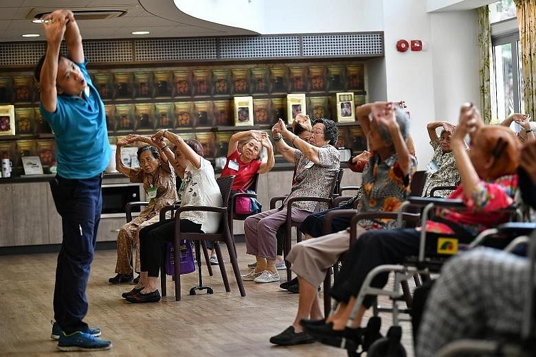 Residents of St Luke's ElderCare Centre in Ayer Rajah taking part in an exercise in February. During phase two, each nursing home resident will be allowed a maximum of two designated visitors to minimise the risk of infection within the nursing homes
