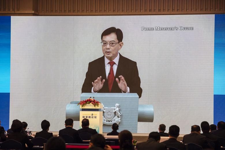 Deputy Prime Minister Heng Swee Keat speaking via video link at the 12th Lujiazui Forum in Shanghai yesterday. The annual forum was held virtually for the first time, with Singapore as the partner city this year.