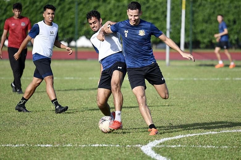 Hougang United striker Stipe Plazibat (right) training ahead of February's Community Shield. Hougang have played just three SPL games since that curtain-raiser owing to the pandemic. But footballers can resume training today. Among the strict rules, 