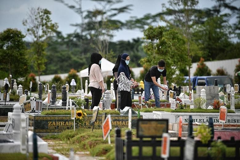 Relatives visiting the graves of their loved ones at the Lim Chu Kang Muslim Cemetery yesterday. ST PHOTO: ARIFFIN JAMAR Left: Breakfast time at 826 Tampines Kopi Point in Tampines Street 81 yesterday. Right: Diners enjoying their meals at a foodcour
