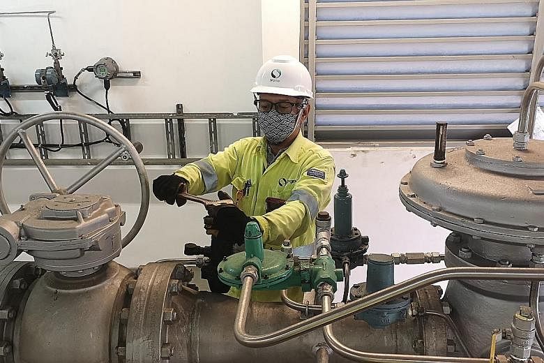 A member of the SP Group gas operations team at an offtake station conducting checks on the gas regulators. The utilities firm is adjusting the gas pressures within the transmission and distribution network for residential and industrial customers as Sing