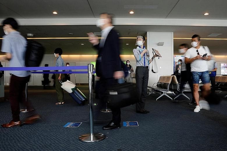 Tokyo's Haneda Airport pictured early this month. Prime Minister Shinzo Abe announced plans to open Japan's borders to business tourists, initially accepting up to 250 daily from countries with low infection rates. PHOTO: REUTERS