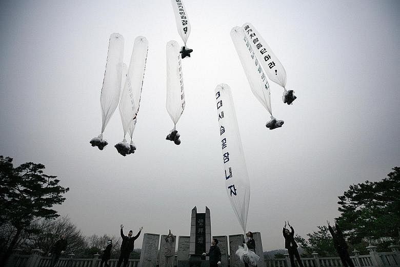 A 2011 file photo showing activists in a park in South Korea releasing balloons carrying leaflets criticising the North.