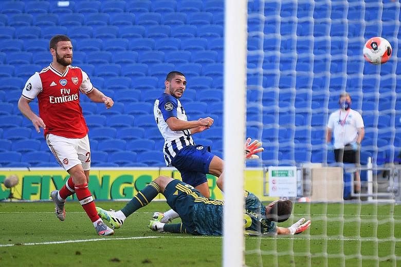 Brighton's Neal Maupay getting to the ball ahead of Arsenal's substitute goalkeeper Emiliano Martinez to tuck it home with virtually the last kick of the Premier League game. Martinez came on after the French striker's challenge on Bernd Leno resulte