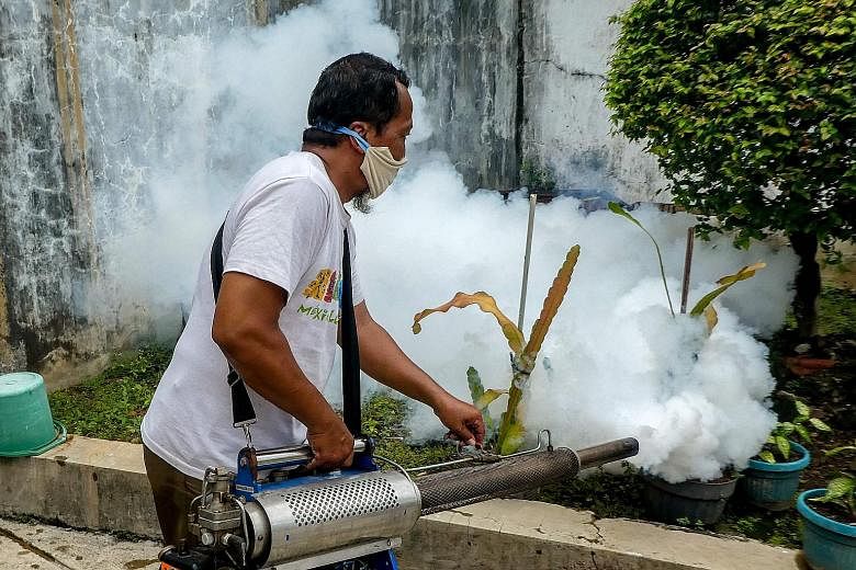 A man carrying out fogging at a housing complex in Jakarta in April. Experts say the restrictions brought about by the Covid-19 pandemic have hampered efforts to prevent dengue fever. PHOTO: AGENCE FRANCE-PRESSE