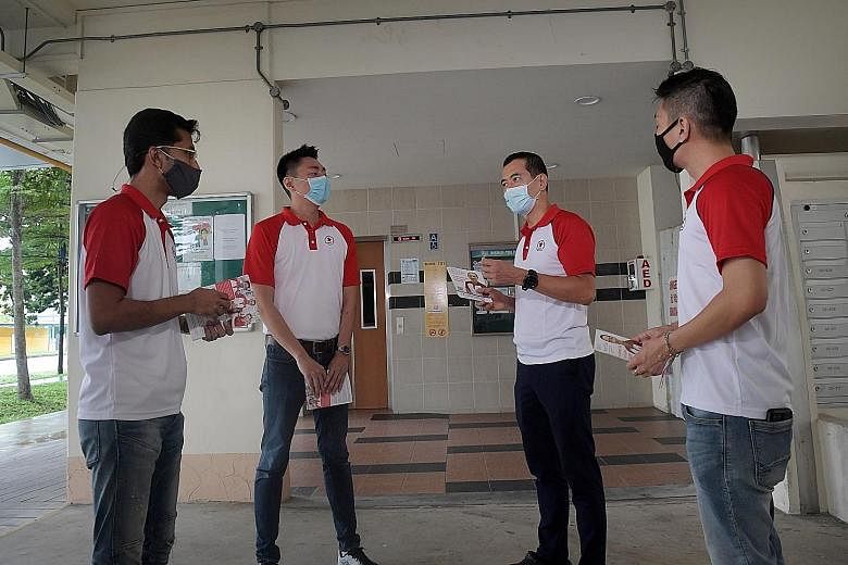 From left: Singapore People's Party candidates Osman Sulaiman, Melvyn Chiu, Steve Chia and Williiamson Lee preparing to hand out fliers and meet residents at Block 131, Bishan Street 12, yesterday.