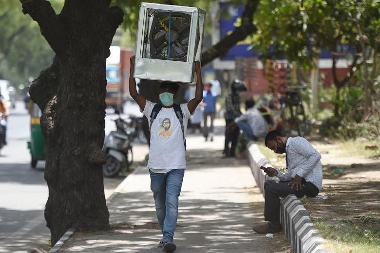 A man carrying an air cooler amid rising temperatures in New Delhi on May 27. India's average temperature rose by around 0.7 deg C between 1901 and 2018, a climate change assessment report says.