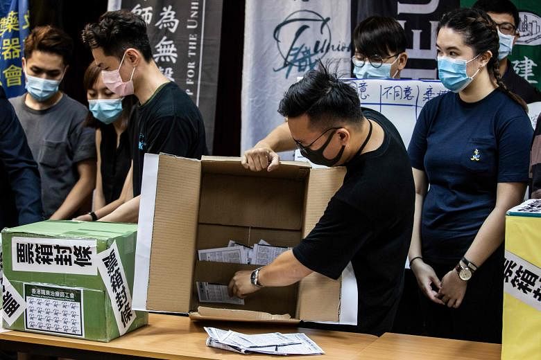 A volunteer emptying a ballot box in Hong Kong last Saturday, following a vote organised by a selection of pro-democracy unions to ask members if they would participate in a citywide strike and if they supported China's plans to impose a new national