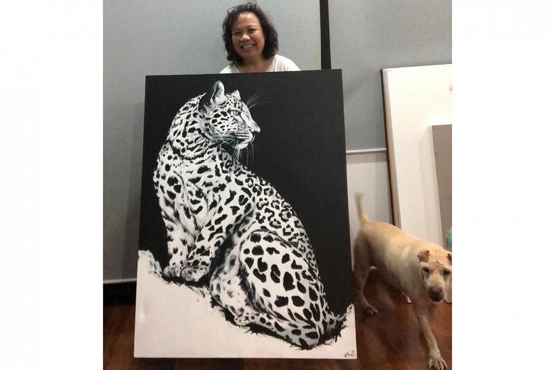 Artist Erica Wee with her painting of a leopard that represents a world on the lookout as the coronavirus was discovered. It is up for sale as part of the Sound of Art Covid-19 Fundraiser.