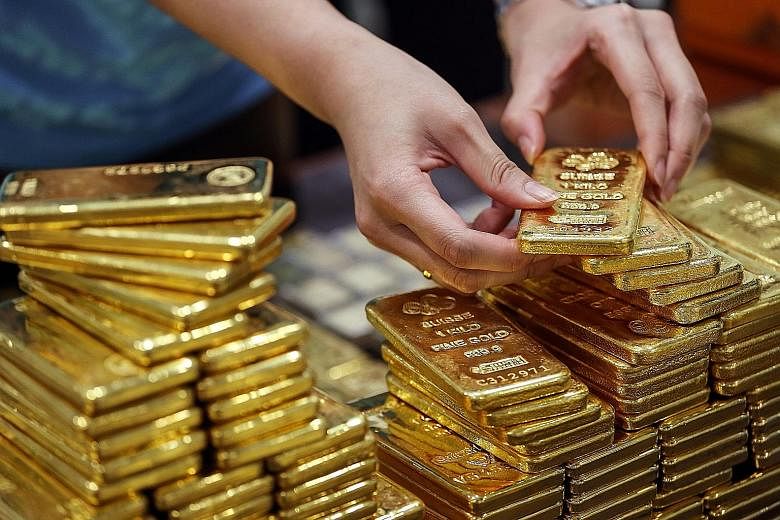Gold is up 15 per cent this year, buoyed by unprecedented stimulus to aid the global economy, which has been hurt by the lockdowns due to the coronavirus pandemic. PHOTO: BLOOMBERG