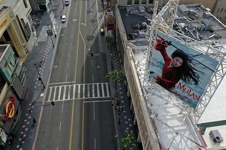 A poster of Mulan the movie by Walt Disney Studios hanging over an empty Hollywood Boulevard during the coronavirus outbreak in Los Angeles. Originally due for release in March, the film is now looking at screening next month, depending on how other 