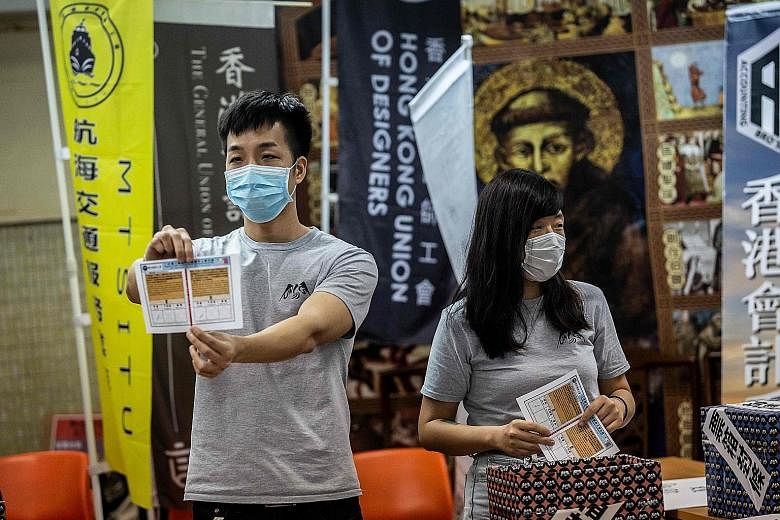 Volunteers holding up ballot papers during counting in Hong Kong last Saturday following a vote on a plan by unions and a student group to consider what actions to take against the draft national security law. However, the measure flopped after the p