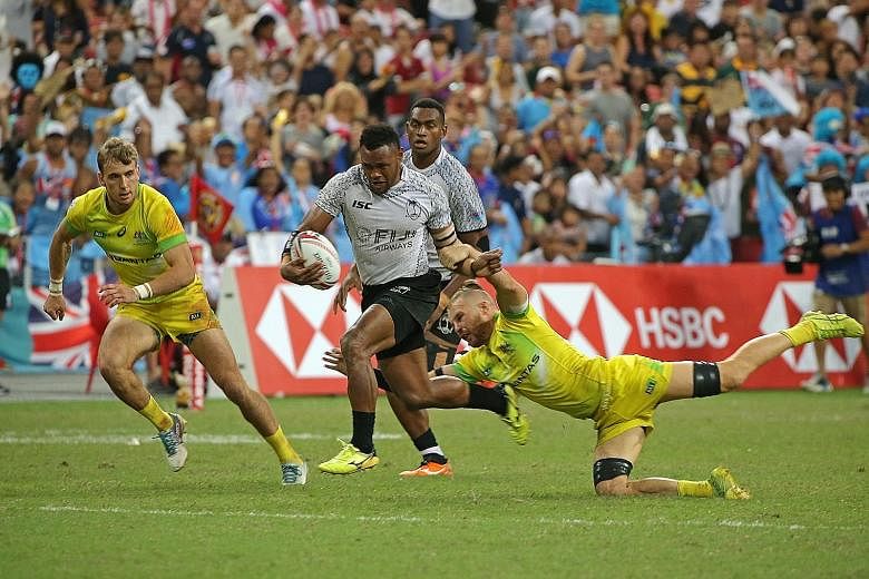 Fiji's Amenoni Nasilasila skipping past the tackle of Australia's Tom Connor during the final of the Singapore Sevens in 2018. The event's fate this year is hanging in the balance due to the coronavirus pandemic.