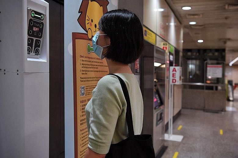 A self-check temperature kiosk at Braddell MRT station, one of five locations that currently have the machines. The kiosks, which allow commuters to take their own temperature within two seconds, will be available at 70 locations by the third quarter