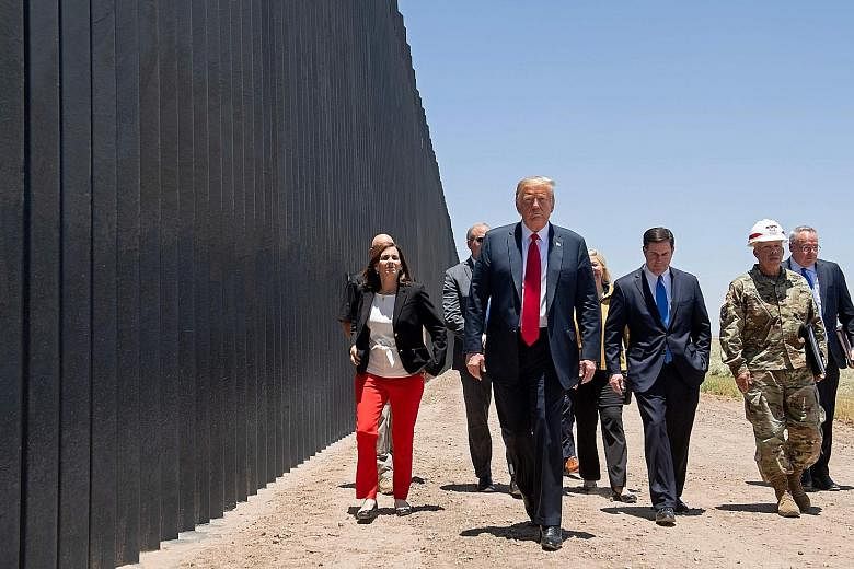 Prior to his campaign appearance in Phoenix, Arizona, on Tuesday, United States President Donald Trump also visited a newly built section of the border wall along the frontier with Mexico where he autographed a plaque commemorating the 200th mile of 