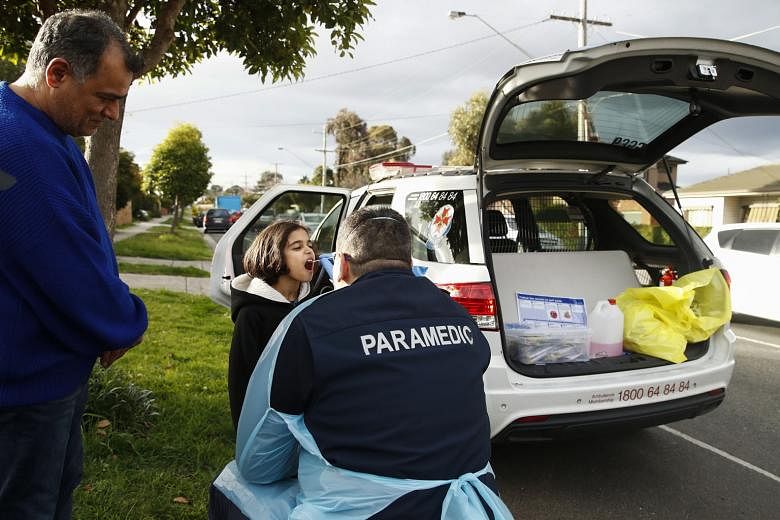 A person being tested for Covid-19 yesterday in Broadmeadows, one of the two worst-hit suburbs in the Australian state of Victoria. Health and human services officials are knocking on doors to check if people have any symptoms of the coronavirus.