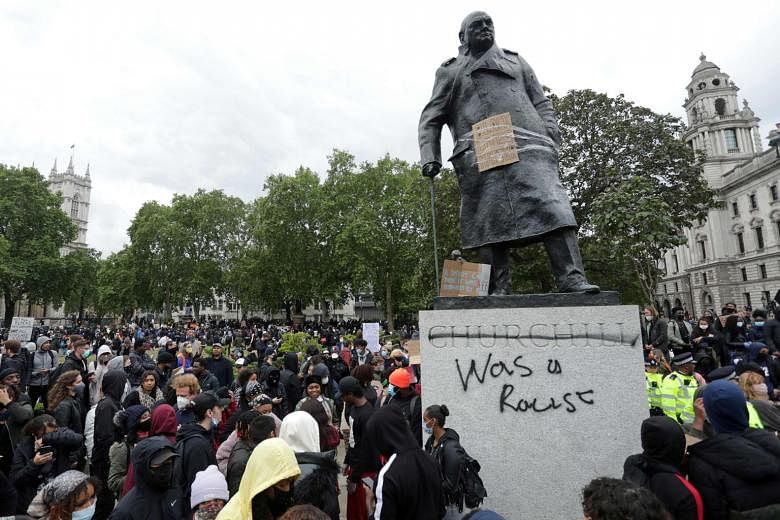 Graffiti scrawled on the statue of former British prime minister Winston Churchill in London earlier this month. PHOTO: AGENCE FRANCE-PRESSE