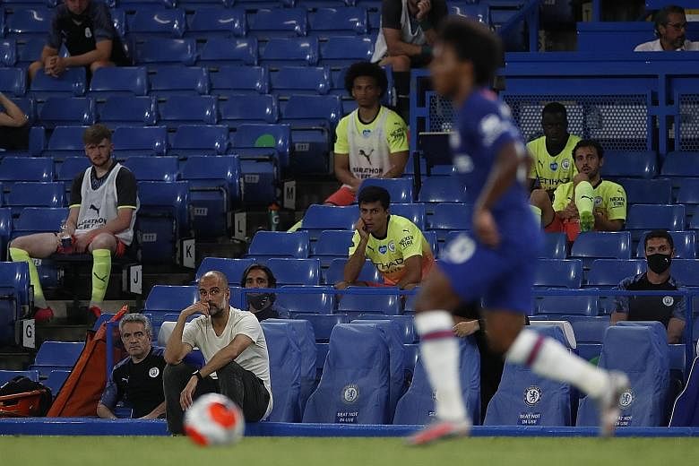 Manchester City boss Pep Guardiola (in white T-shirt) watching Chelsea midfielder Willian bring the ball forward in their Premier League game at Stamford Bridge on Thursday. The Brazilian scored the winner from the spot, with the 2-1 result dethronin
