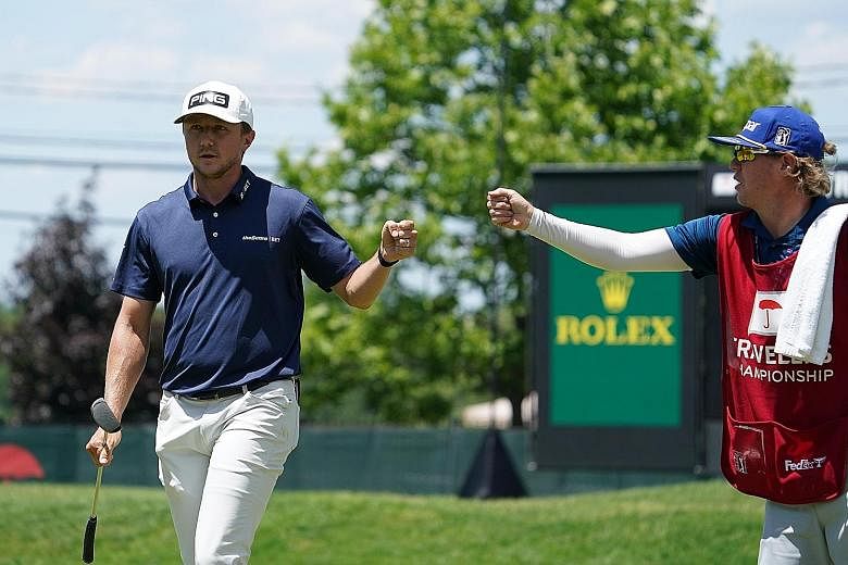 Canadian golfer Mackenzie Hughes fist-bumps his caddie after another good shot in a superb opening round of 60 at the Travelers Championship in Cromwell, Connecticut. 