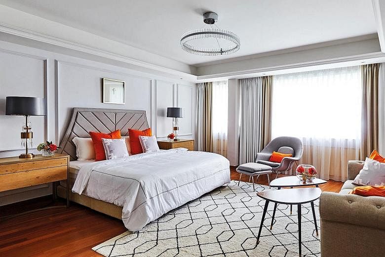 Bright orange cushions give a cheerful vibe to the master suite (above).