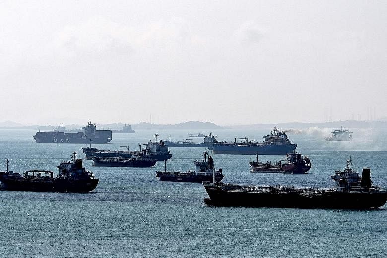 Oil tankers seen anchored off the western shores of Singapore in February 2018. Some 82.5 million barrels of crude and oil products were sitting in 67 vessels parked off Singapore and in the Malacca Strait as of Tuesday, according to data intelligence fir